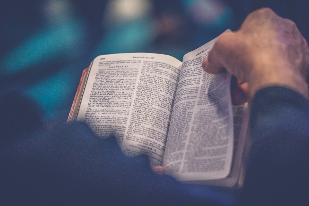 Hands holding an open Bible during study